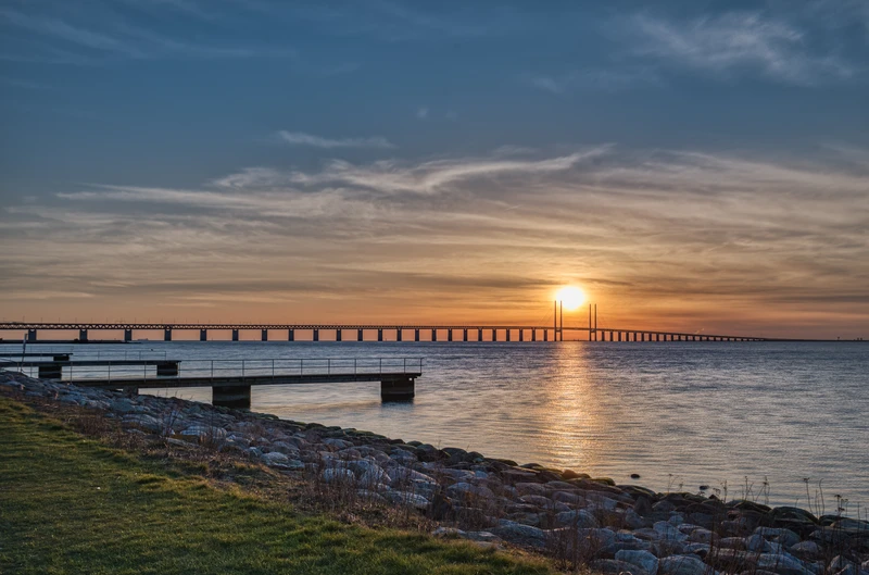 Puente de Øresund al atardecer, visto desde un embarcadero en la orilla