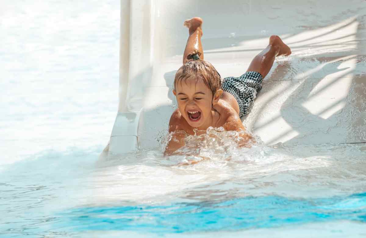 Water park in Sweden Close-up of a small child falling off a water slide at a theme park in Sweden.