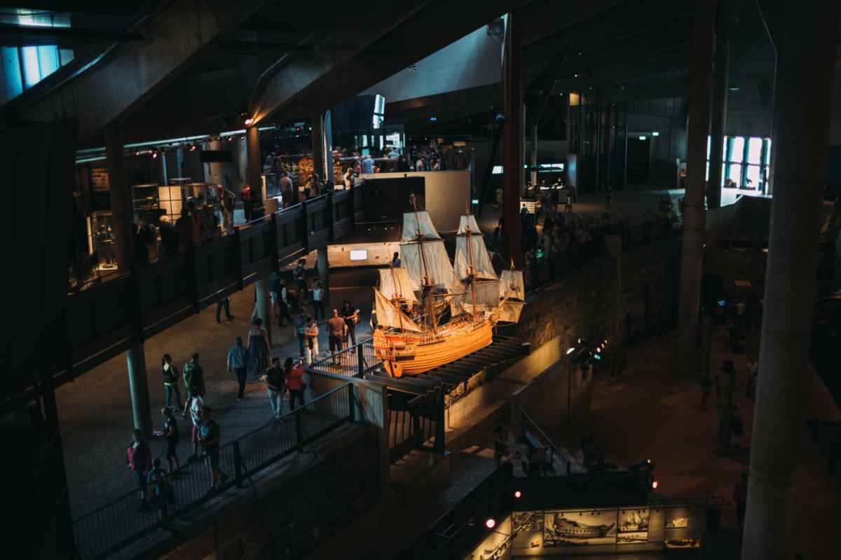 Interior of the Vasa Museum in Stockholm with visitors walking around the massive preserved 17th-century warship.