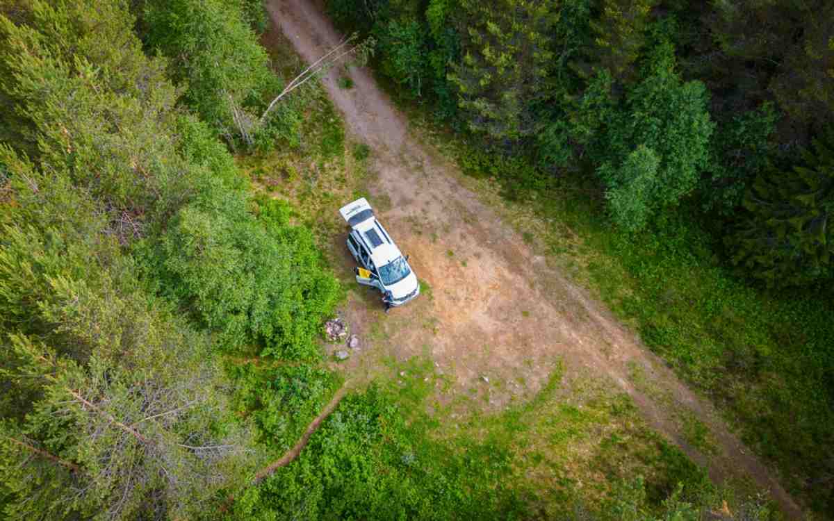 A campervan remains parked in the solitude of the Swedish forest.