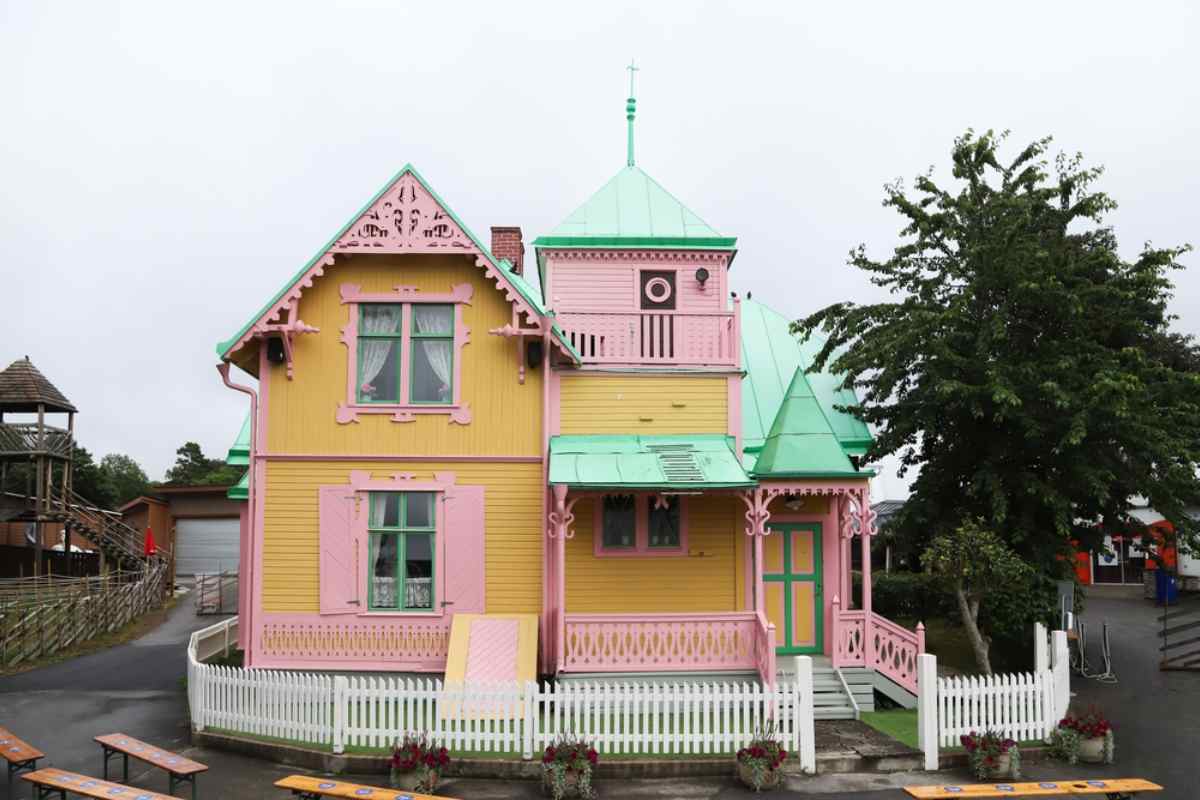 General view of the facade of Pippi's original house, Villa Villekulla, with particular pink and orange colors.