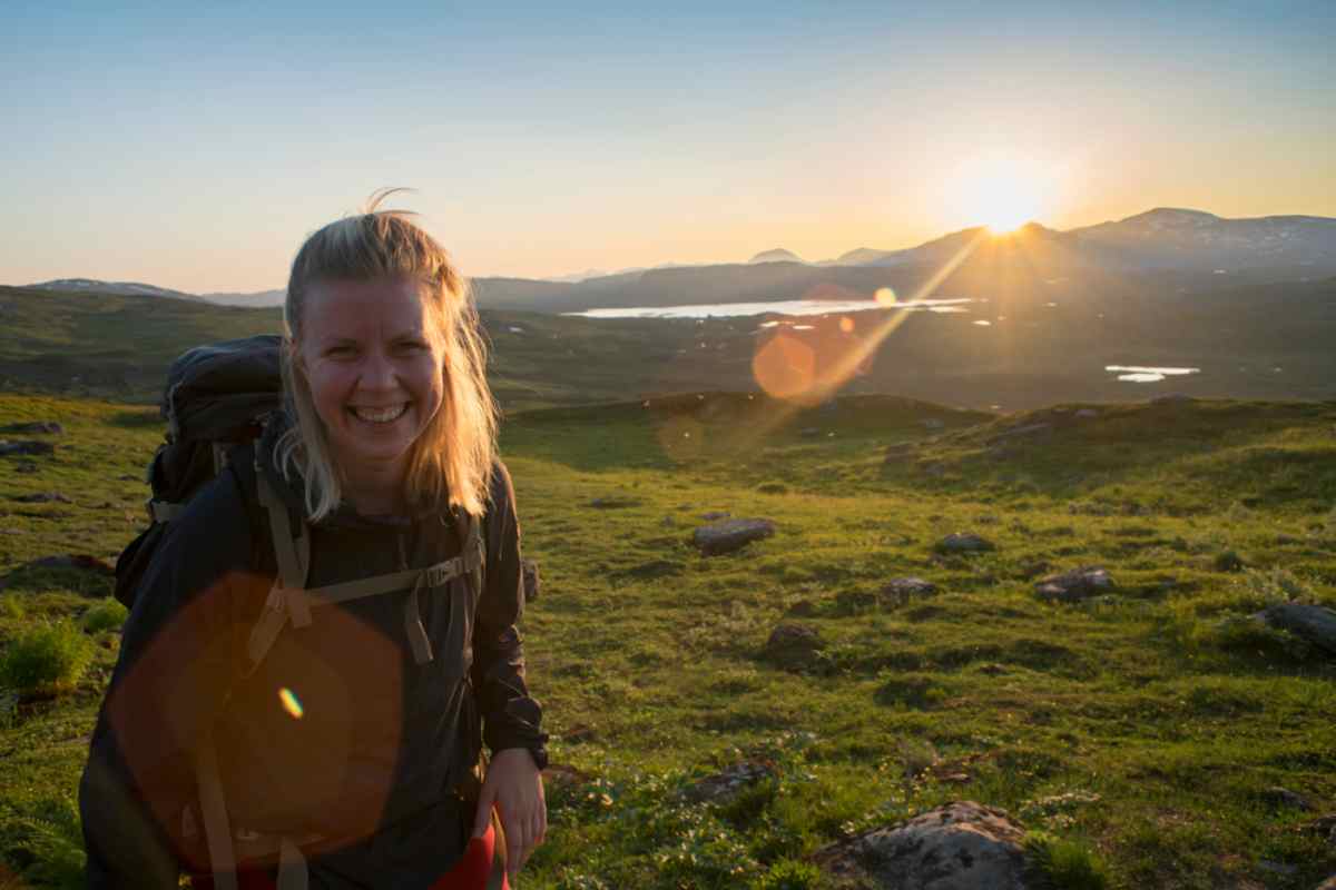 Swedish Lapland Hiker smiling under the midnight sun in Swedish Lapland.