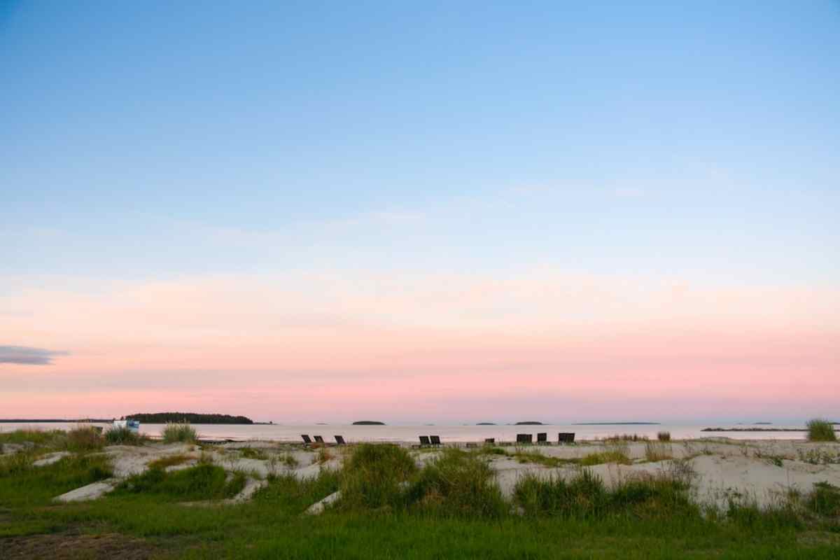 Sweden’s coast Pastel sunset over sandy dunes and calm sea on Sweden’s coast.