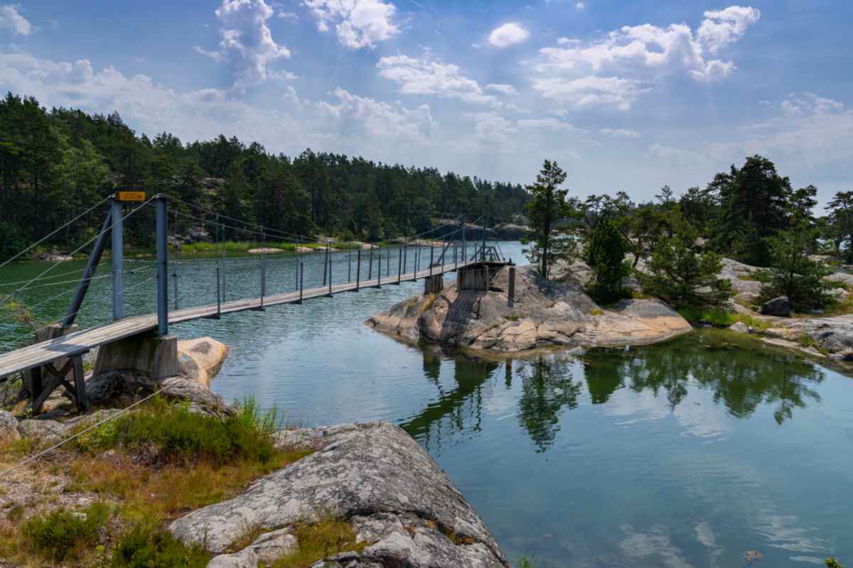 Footbridge linking rocky islands at Stendörren Nature Reserve, archipelago scenery on Sweden's coast near Stockholm.