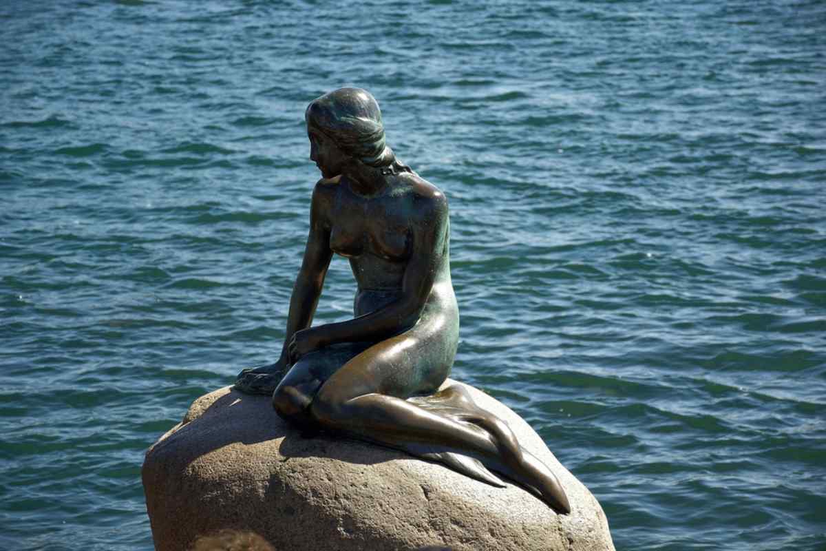 Kopenhagens kleine Meerjungfrau Die Statue der kleinen Meerjungfrau sitzt auf einem Felsen am Meer in Kopenhagen, Dänemark.